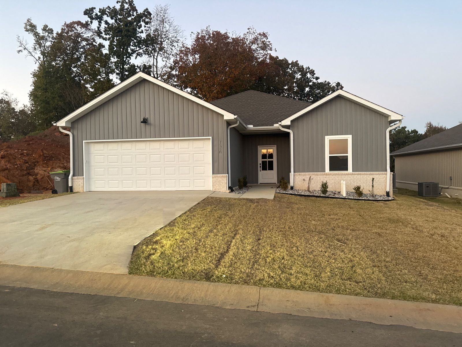 A new home in Mountain Falls Estates with fall trees behind it