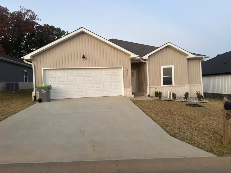A tan home with a white garage door on Everest Street
