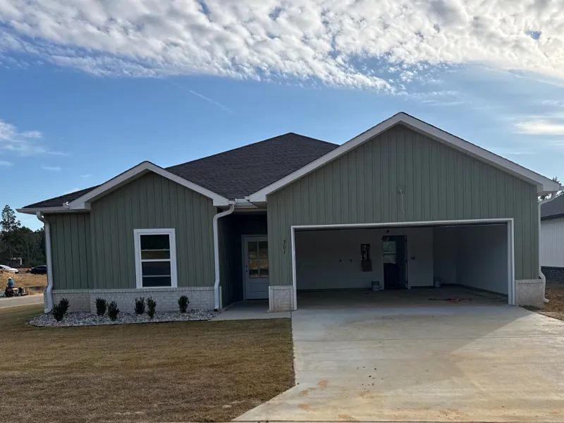 A green home with a two-car garage on Fuji Drive